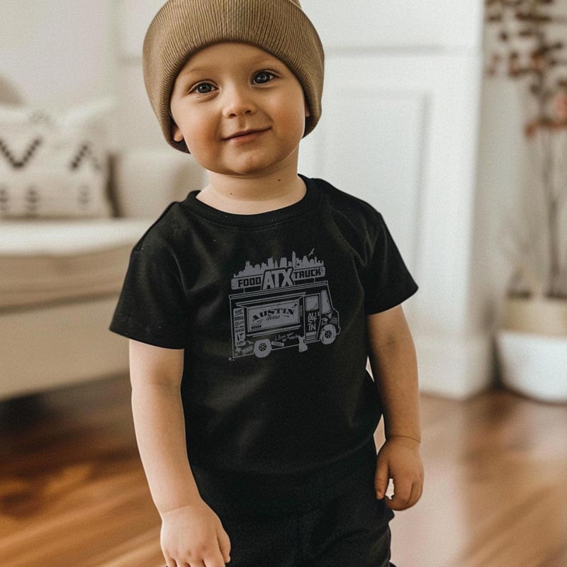Little model wearing our ATX Food Truck toddler t-shirt with playful food truck graphic – fun Austin foodie shirt for kids