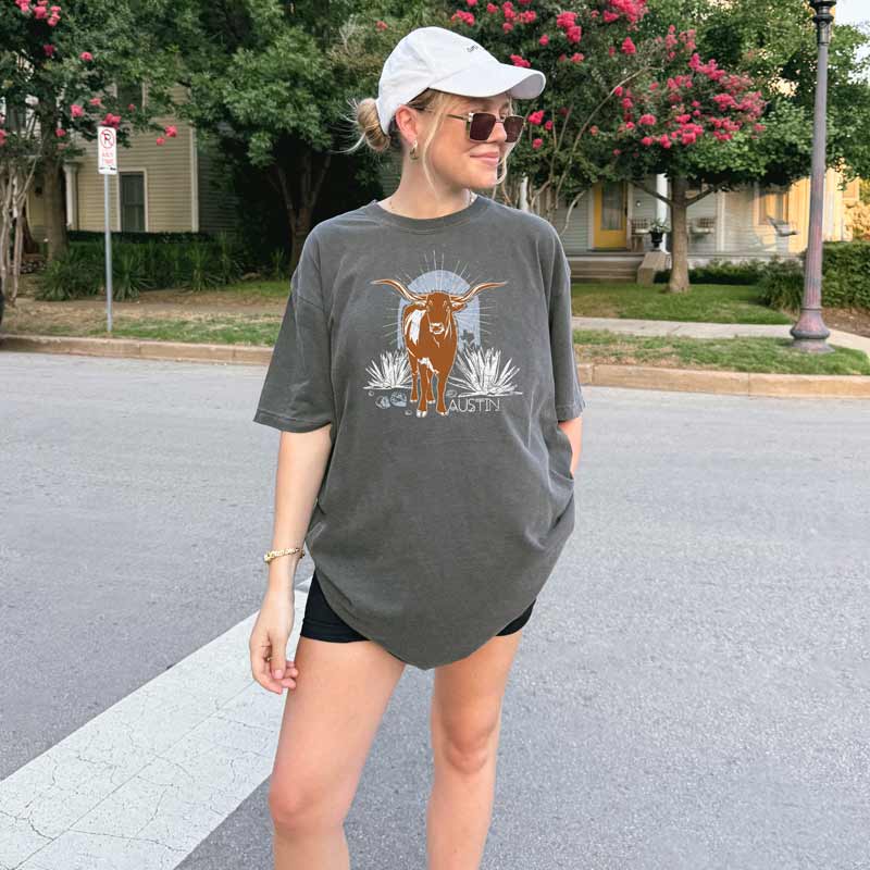 Model wearing ATX Steer Comfort Colors T-shirt with vintage-style Texas graphic