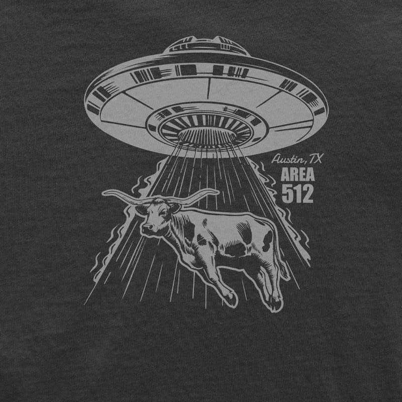 Black t-shirt with a graphic of a UFO abducting a cow, labeled 'Austin, TX Area 512', on a black background.