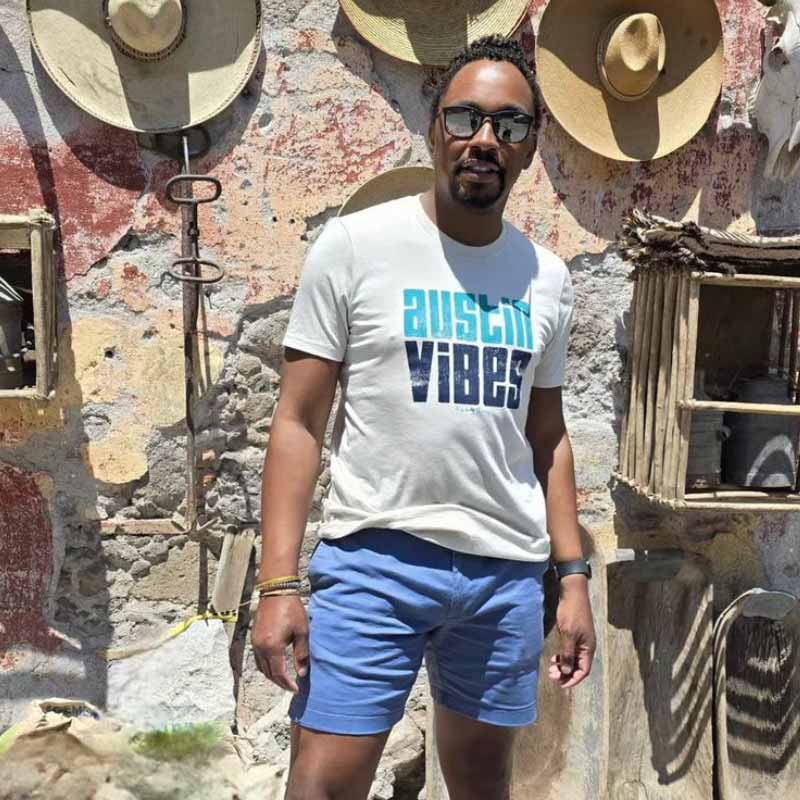 Model wearing Austin Vibes T-shirt, showcasing bright and playful local design