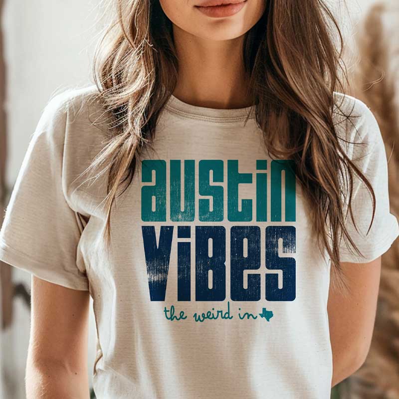 Model wearing Austin Vibes T-shirt, showcasing bright and playful local design