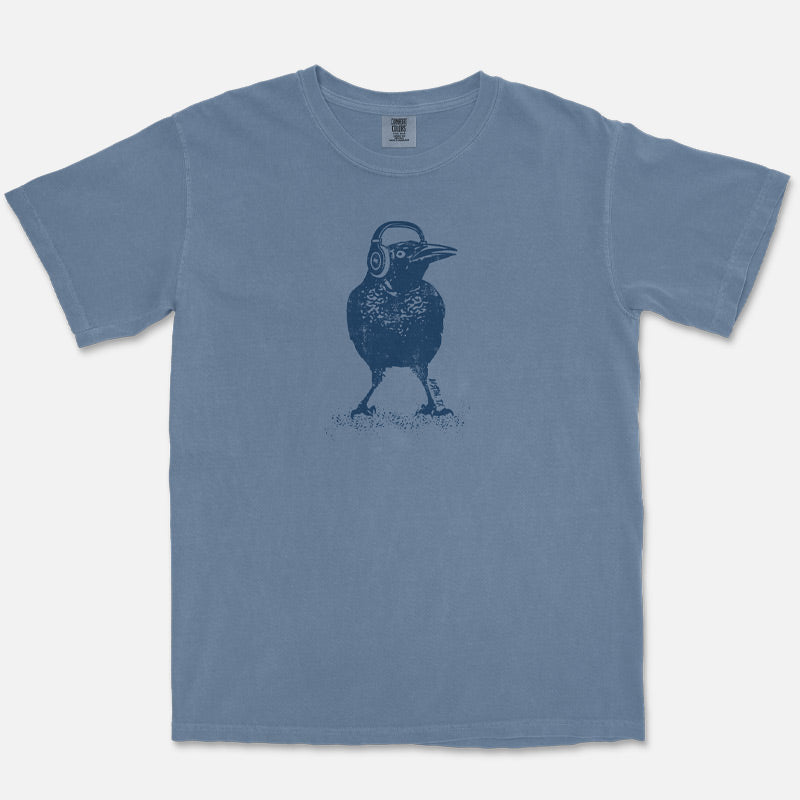 Austin grackle wearing headphones graphic printed on Comfort Colors Blue Jean heavyweight t-shirt