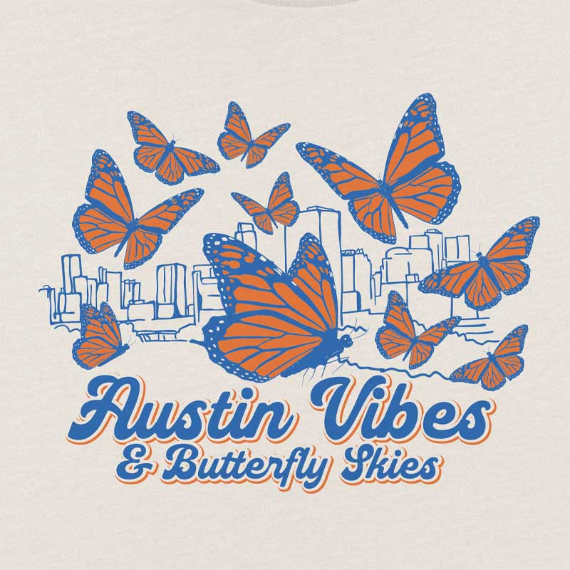 T-shirt design with orange and blue butterflies and 'Austin Vibes & Butterfly Skies' text on a beige background.
