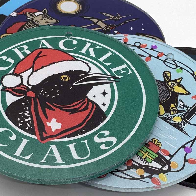 Christmas Ornaments with festive designs and 'Grackle Claus' branding.