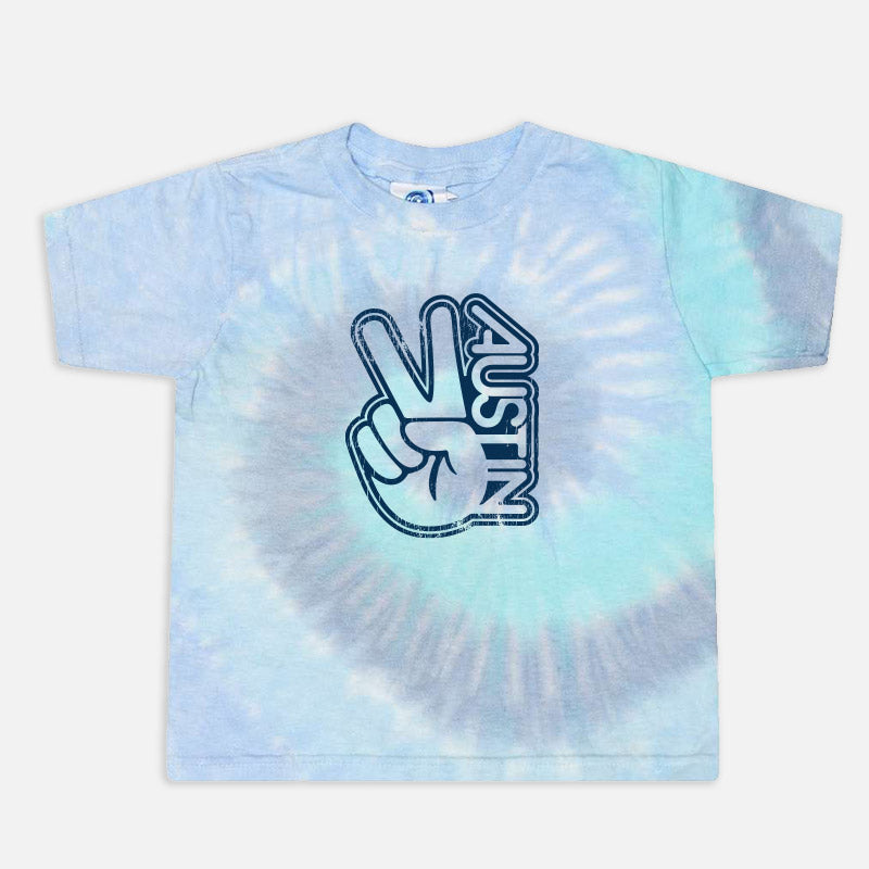 Groovy Austin Toddler Tee in Lagoon tie-dye shown flat, highlighting the blue-green pattern and bold retro lettering.