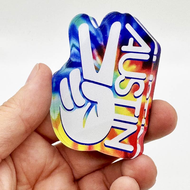 Bright and funky tie-dye acrylic magnet reading "Groovy Austin"