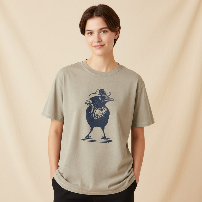 Person wearing a beige t-shirt with a graphic design on a beige background