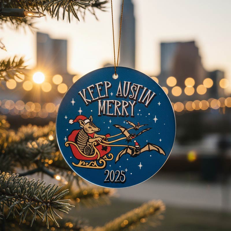 Decorative Christmas ornament with 'Keep Austin Merry' text and cityscape background