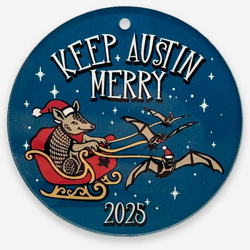 Circular ornament with 'Keep Austin Merry' text, festive design, and '2025' on a blue background.