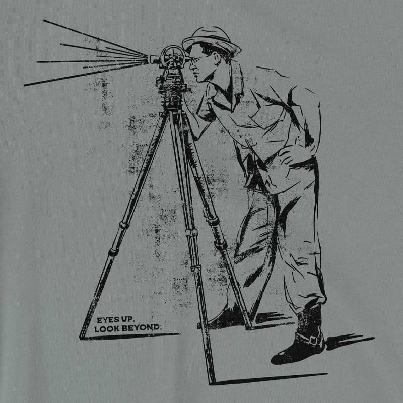 Close-up of telescope graphic and "Eyes Up, Look Beyond" text on soft cotton fabric