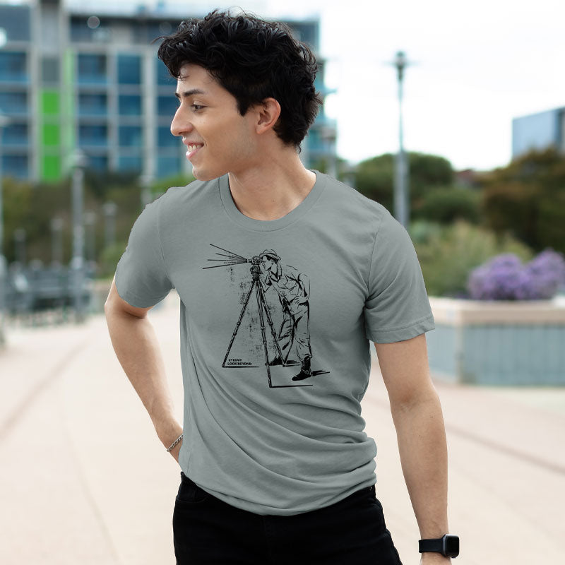 Model wearing retro telescope t-shirt with inspirational message, standing outdoors