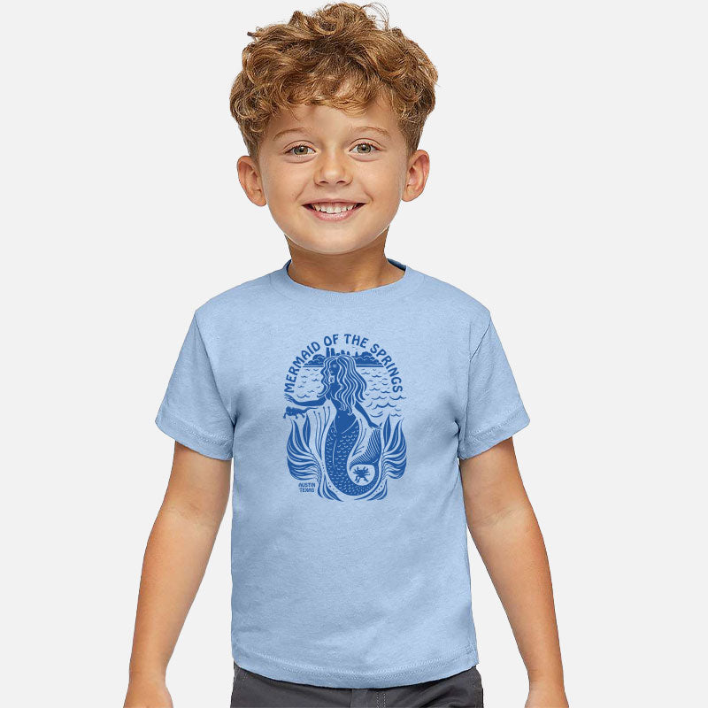 Child wearing a light blue t-shirt with a mermaid design on a white background