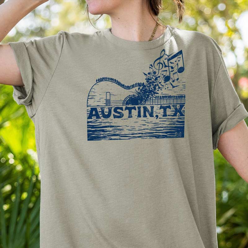 Model wearing ATX Music Bridge T-shirt, blending city skyline and live music theme