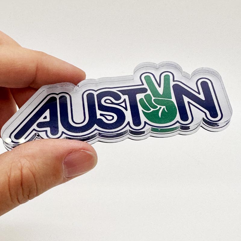 Side view of Peace Austin magnet showing .25-inch thick acrylic layer