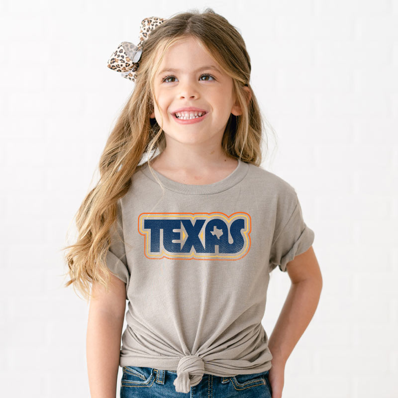 Youth model wearing our Retro Texas youth t-shirt with vintage-style Texas graphic – bold and fun Lone Star tee for kids