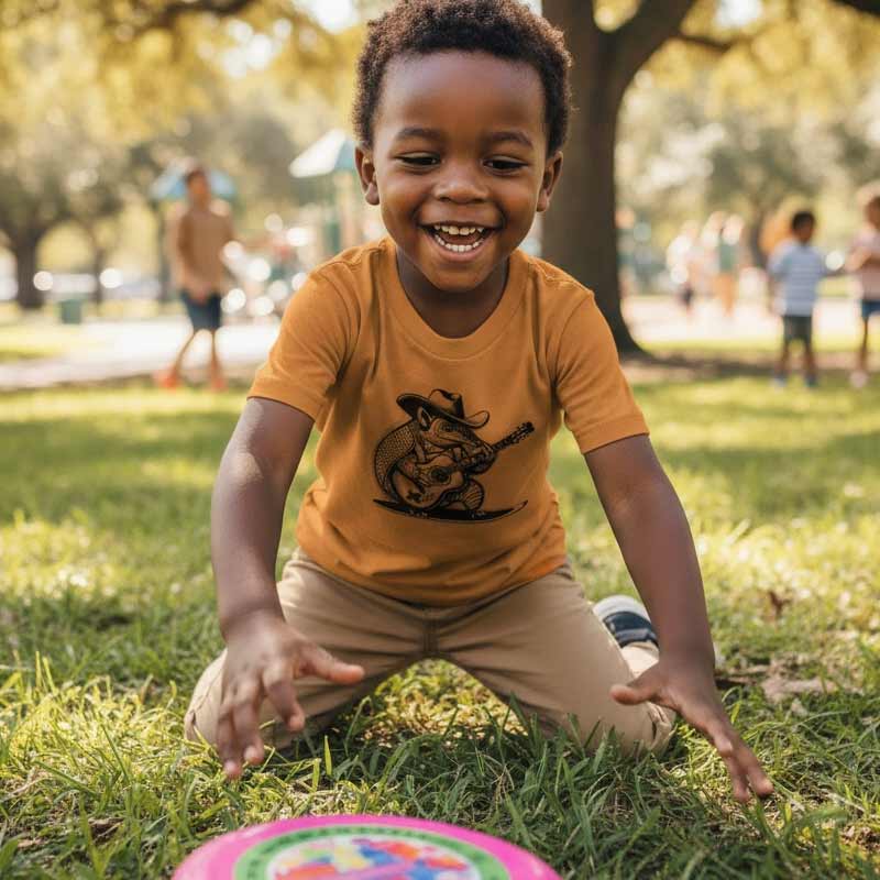 Child sitting on grass in a park with a colorful object in front