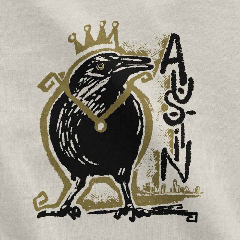 Close-up of crowned grackle artwork on toddler t-shirt – whimsical and regal bird design