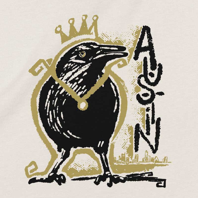 Close-up of crowned grackle artwork on youth t-shirt – quirky and regal bird design