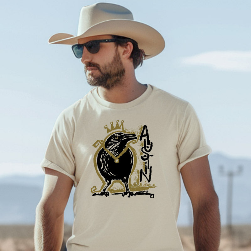 Adult wearing Royal Squawk Austin t-shirt featuring a crowned grackle – fun and stylish ATX pride shirt