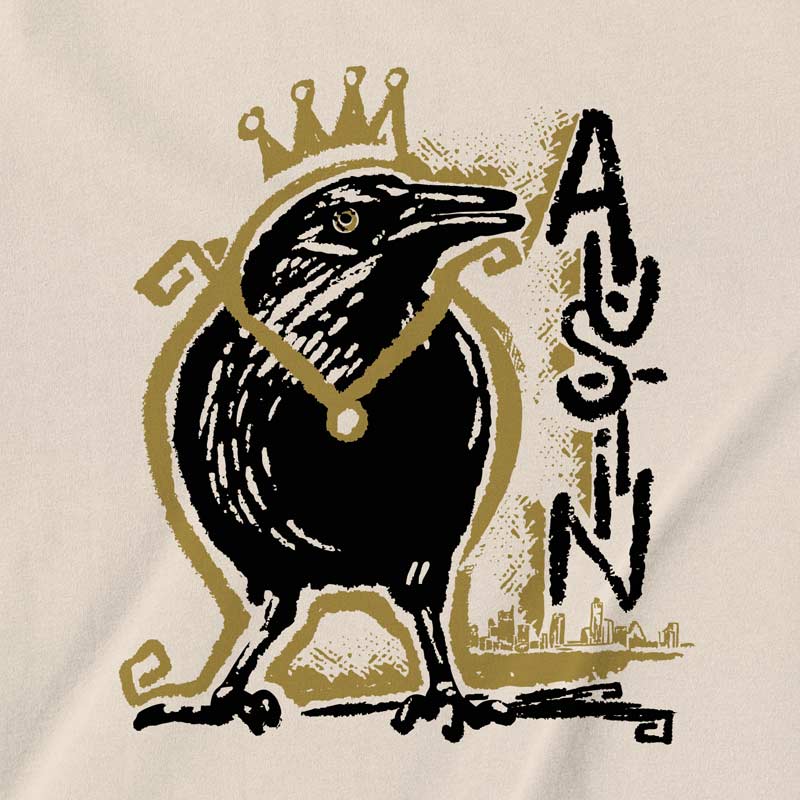 Close-up of crowned grackle artwork on adult t-shirt – playful and regal Austin bird design