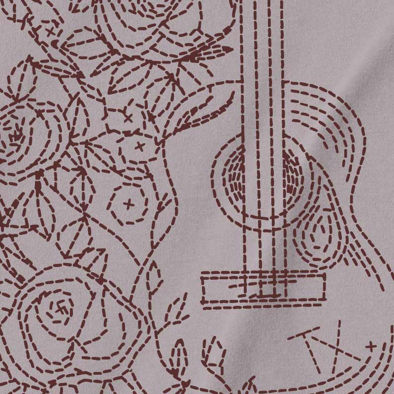 Pattern of a guitar and roses on fabric with brown thread.