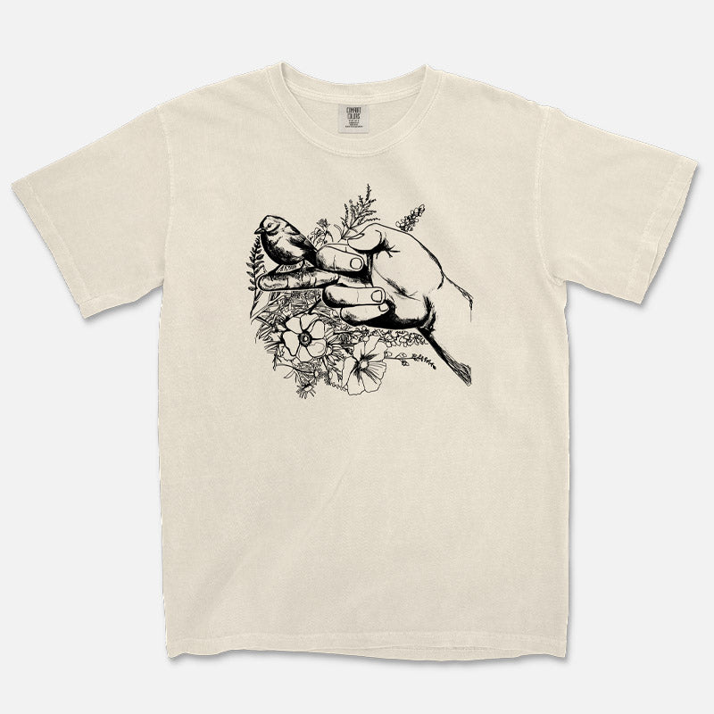 T-shirt featuring bird perched on raised middle finger with floral background – edgy and playful graphic design