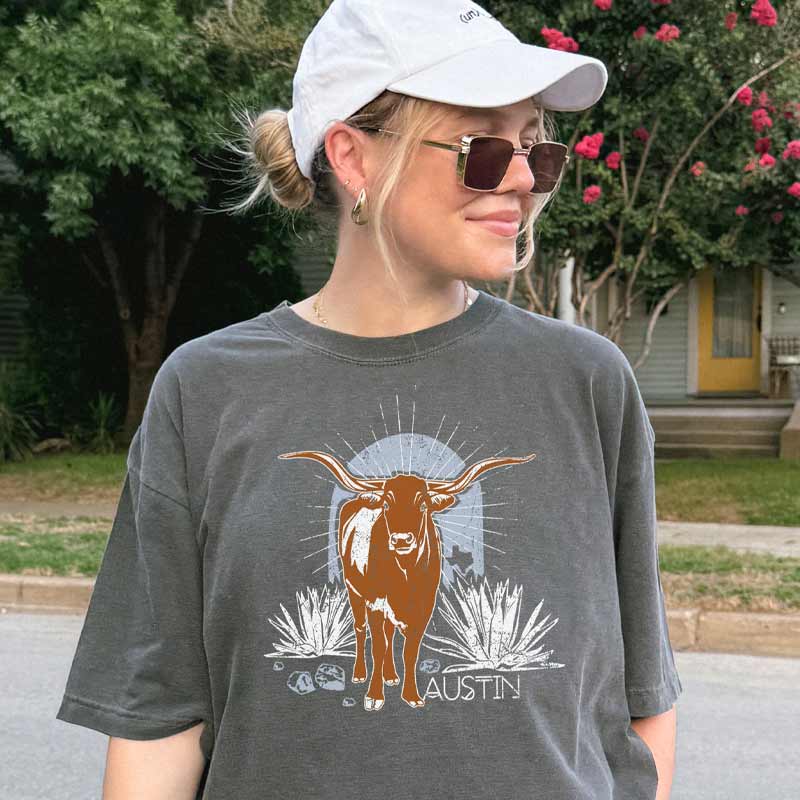 Model wearing ATX Steer Comfort Colors T-shirt with vintage-style Texas graphic
