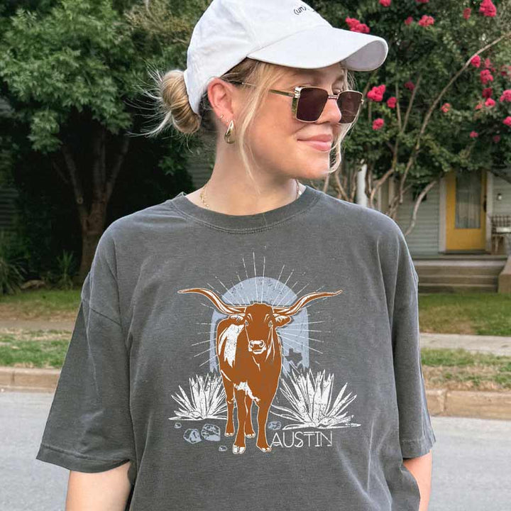 Model wearing ATX Steer Comfort Colors T-shirt with vintage-style Texas graphic