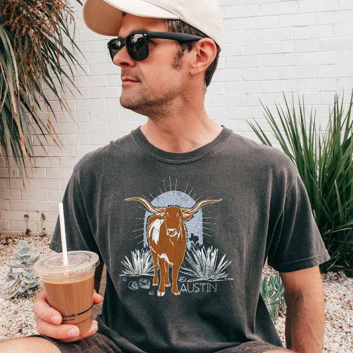 Model wearing ATX Steer Comfort Colors T-shirt with vintage-style Texas graphic