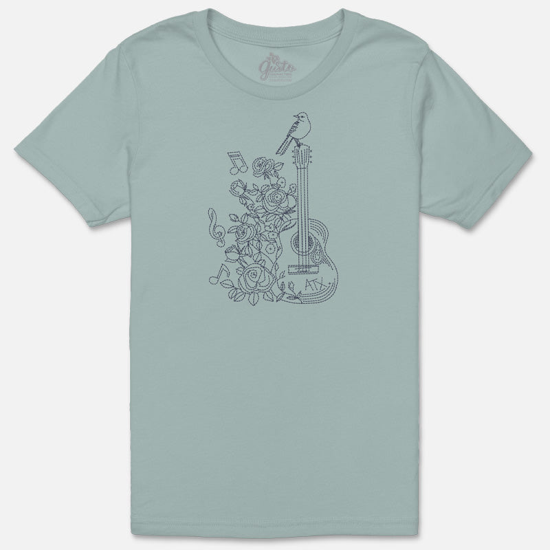 Flat lay of the Songbird & Strings tee showing the detailed bird and guitar design on soft garment-dyed cotton.