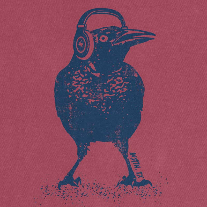 Close up of Austin grackle wearing headphones graphic printed on Comfort Colors Brick heavyweight t-shirt