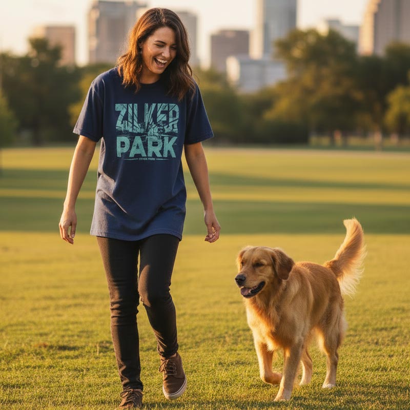 Woman walking a dog in a park with a city skyline in the background