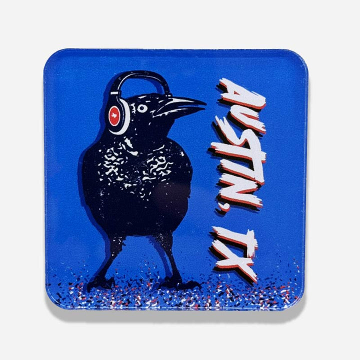 Acrylic magnet featuring a cartoon grackle wearing headphones, inspired by Austin, Texas culture.