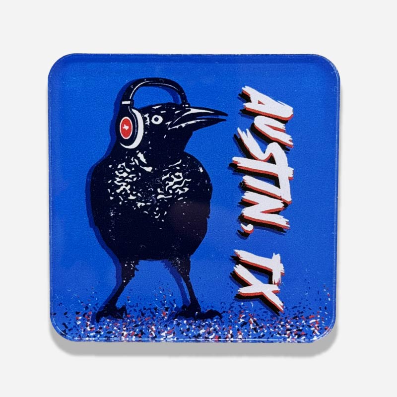 Acrylic magnet featuring a cartoon grackle wearing headphones, inspired by Austin, Texas culture.