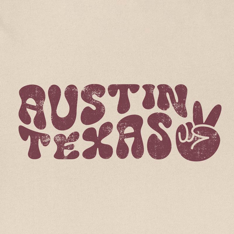 Close-up of funky, colorful Austin text and peace sign graphic printed on t-shirt