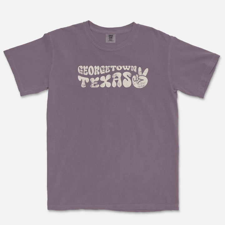 Wine Georgetown Texas t-shirt featuring retro distressed groovy lettering and a playful peace-sign graphic in a vintage-inspired design.