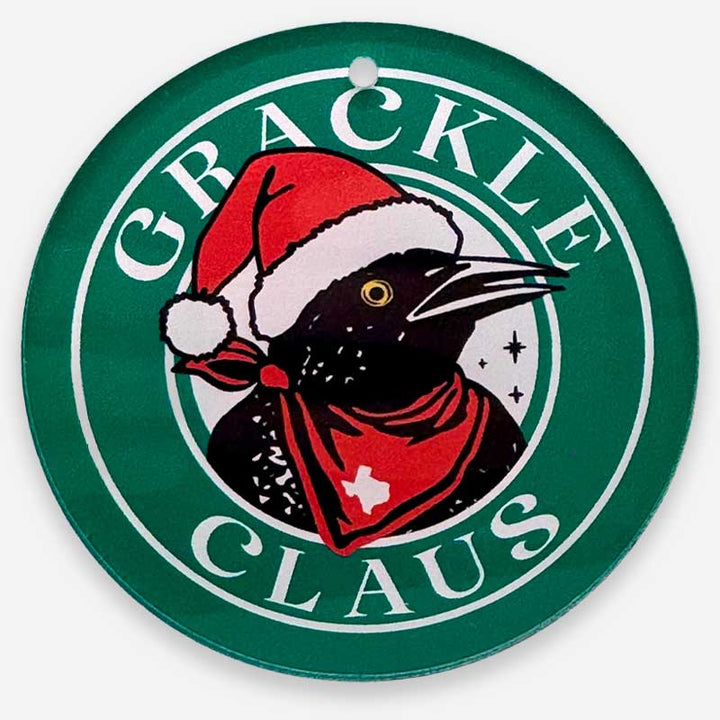Circular sign with a black bird wearing a Santa hat and red scarf, surrounded by &