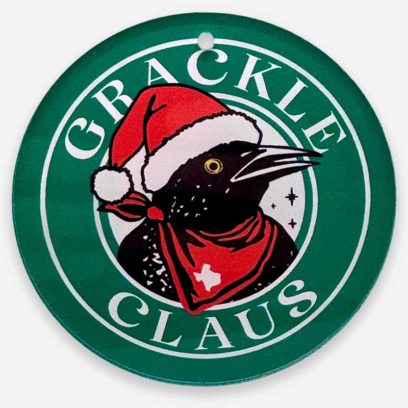 Circular sign with a black bird wearing a Santa hat and red scarf, surrounded by 'Grackle Claus' text on a green background.