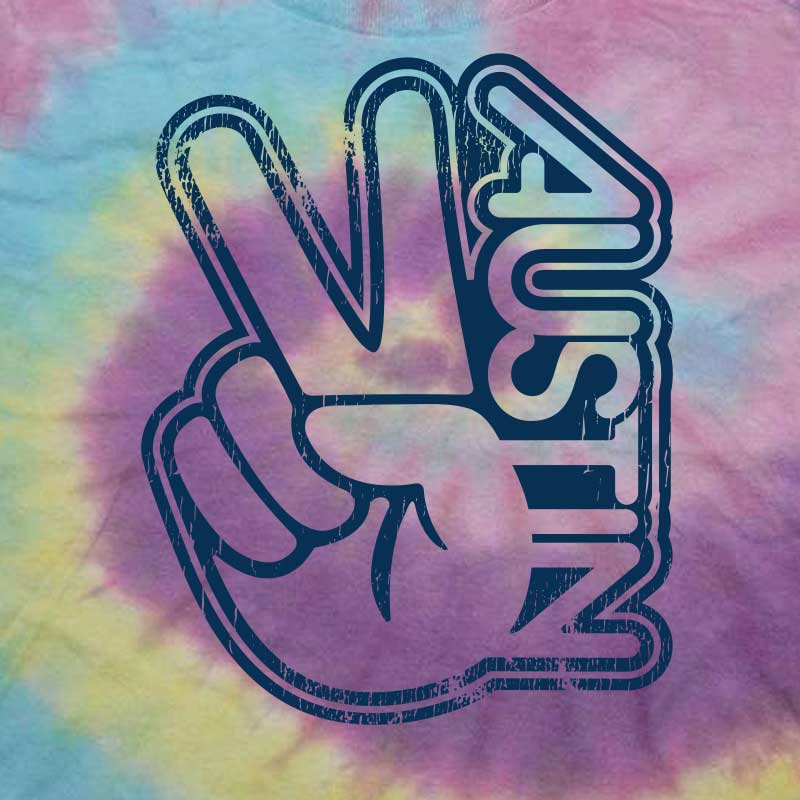 Close-up of the "Groovy Austin" retro print on colorful tie-dye cotton, showing fabric texture and graphic detail.