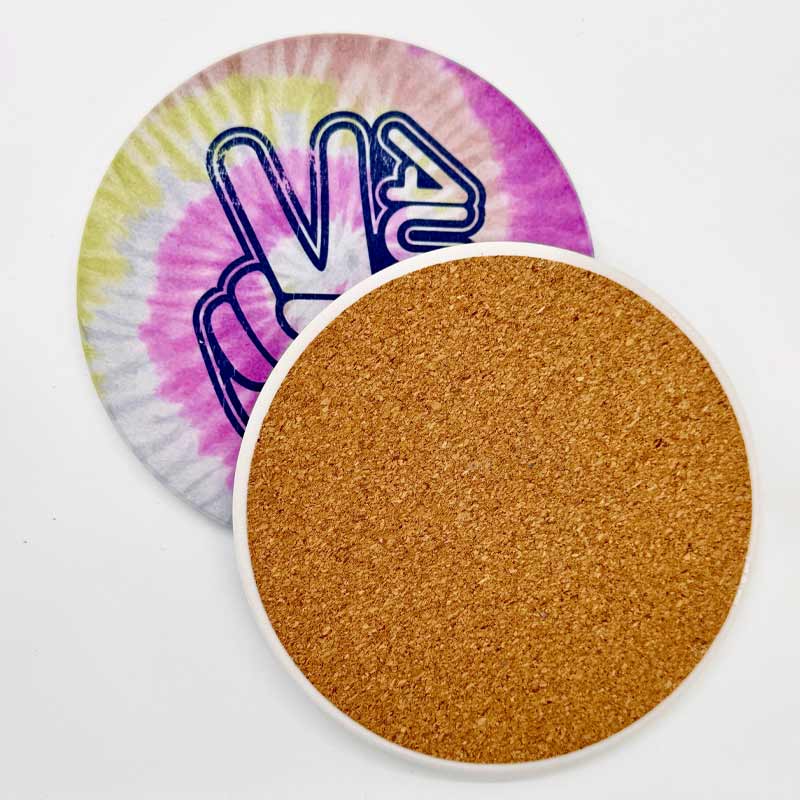 Round coaster with tie-dye design and cork back on a white background