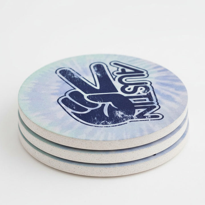 Set of three tie-dye coasters with a peace sign and 'Austin' text on a white background