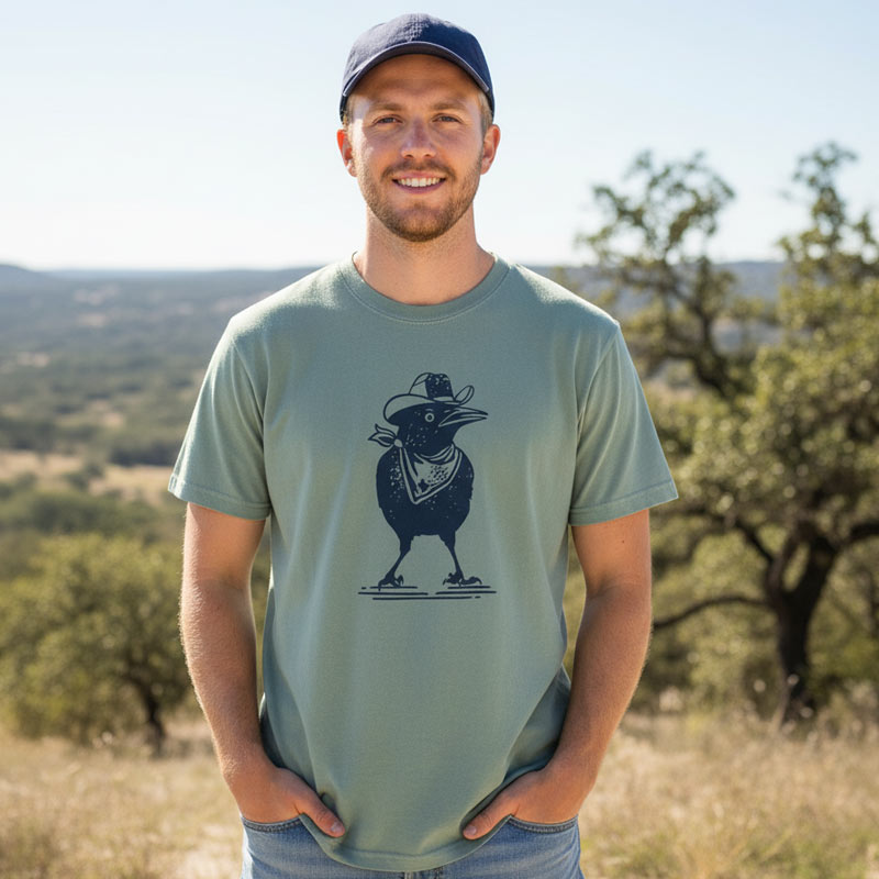 Man wearing a green t-shirt with a graphic design outdoors