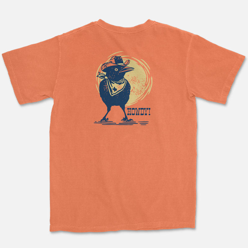 Howdy Grackle Tee featuring a cartoon grackle wearing a cowboy hat and bandana with the word Howdy printed on a soft unisex cotton shirt by Gusto Graphic Tees.