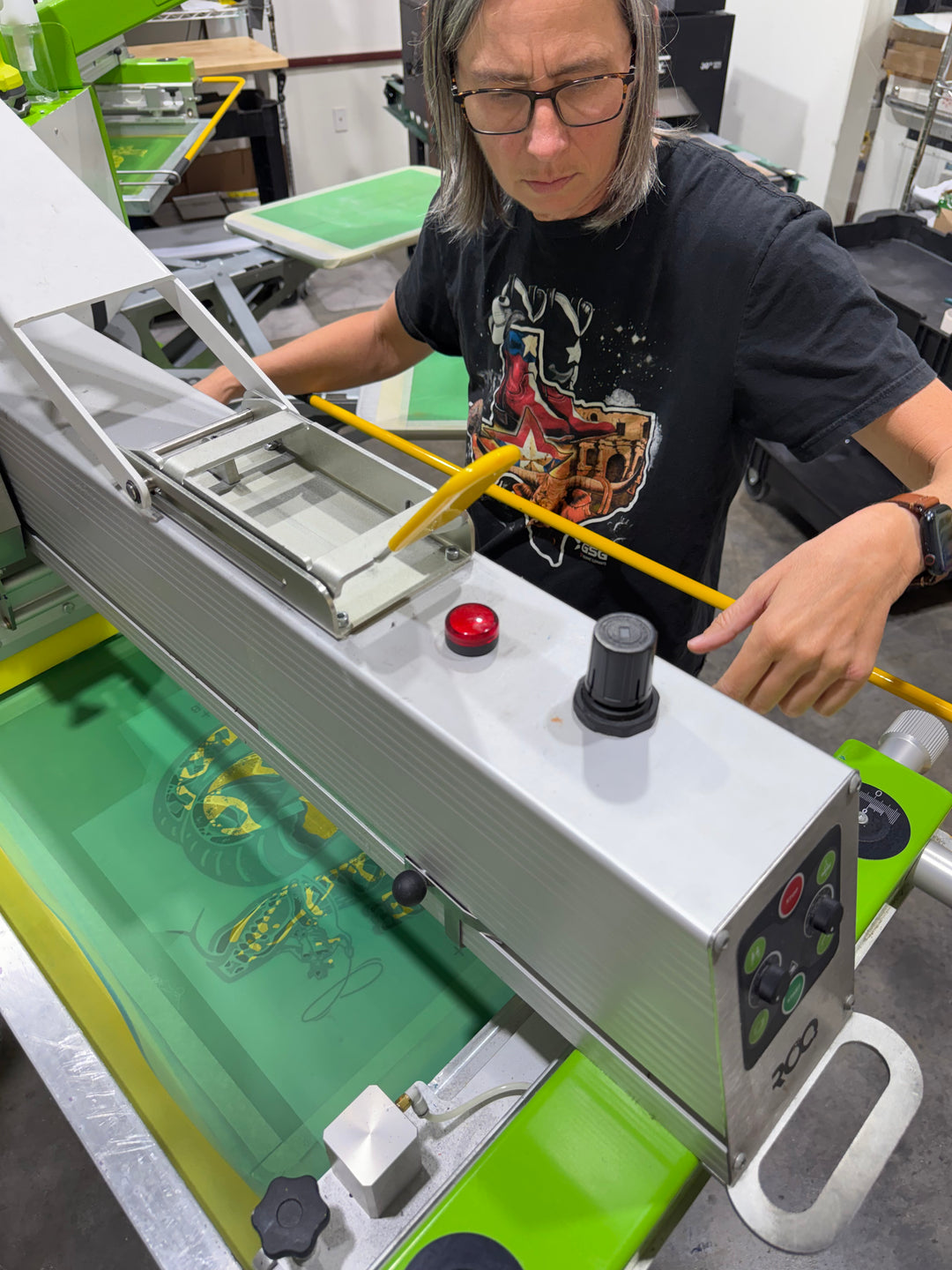 Person operating a machine with control panel in an industrial setting