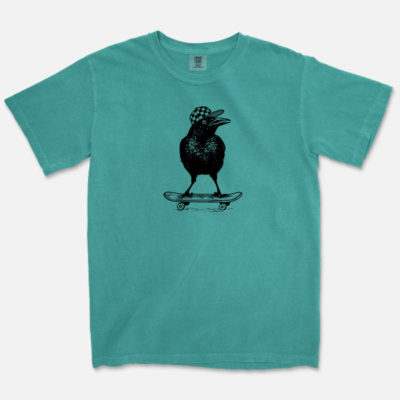 Seafoam Comfort Colors  t-shirt with a black graphic of a bird on a skateboard on a white background