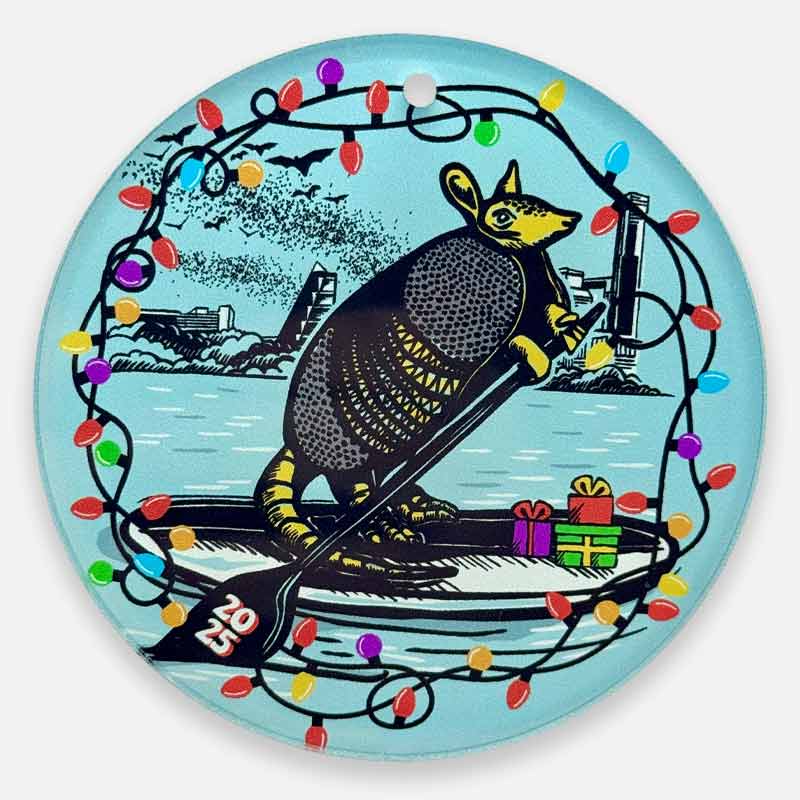 Decorative plate with an armadillo, Christmas lights, and presents on a blue background