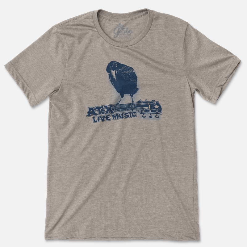 T-shirt featuring a crow perched on a guitar neck with bold “ATX” text below