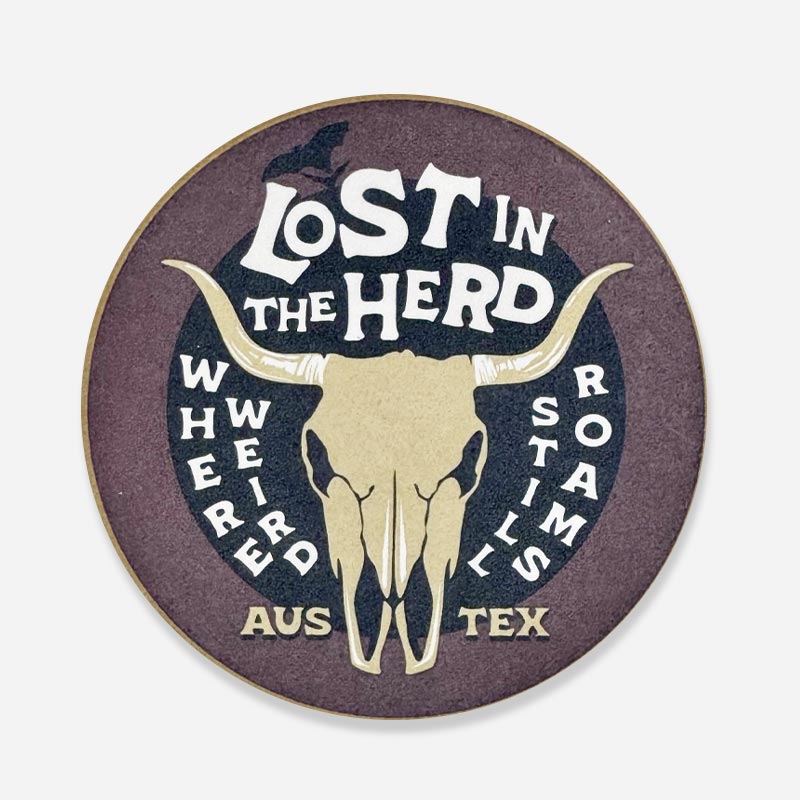 Lost In The Herd sandstone coaster with phrases “Lost in the Herd,” “Here weird still roams,” and “Austin, Texas” in a playful design on natural stone.