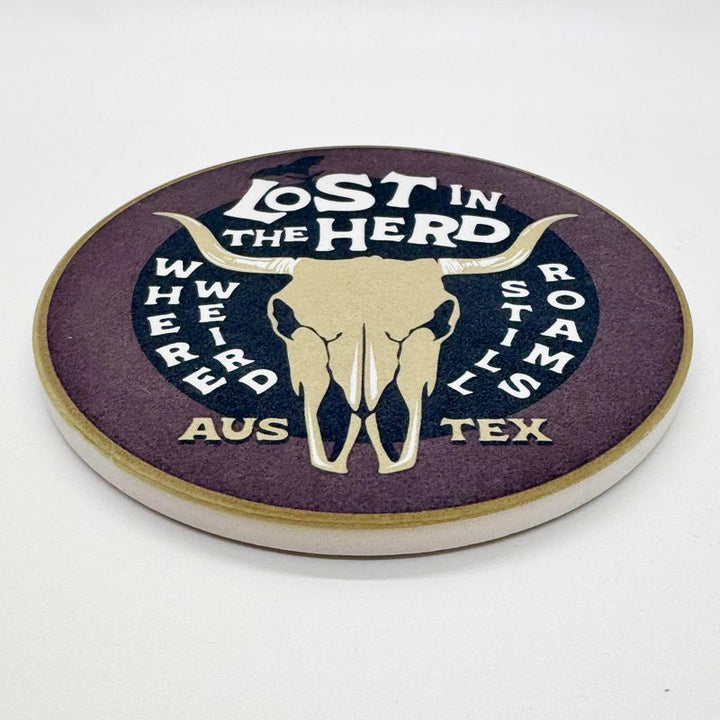 Round coaster with a bull skull design and text on a white background
