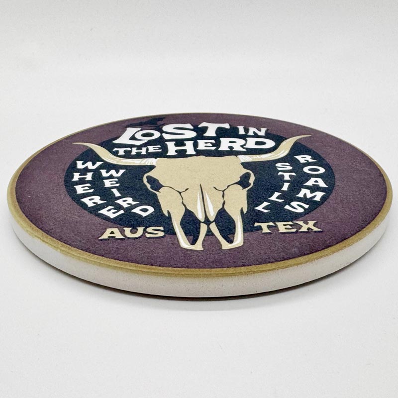 Round coaster with 'Lost in the Herd' design on a white background